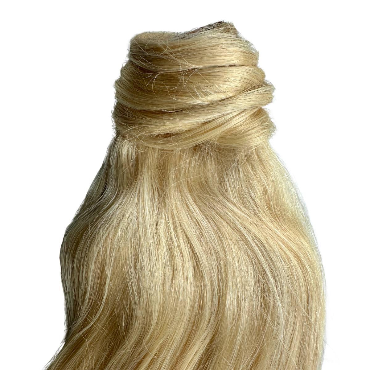 Close-up of 20" Bleach Blonde silky hair texture and color HookedOnBundles Virgin Hair
